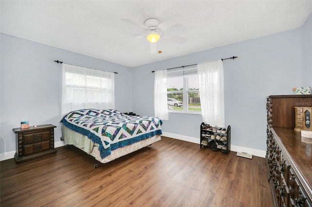 bedroom with ceiling fan and dark hardwood / wood-style flooring