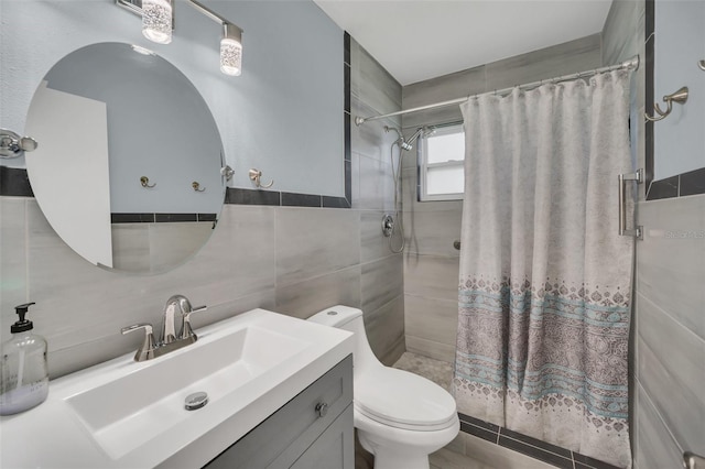 bathroom featuring a shower with curtain, vanity, toilet, and tile walls