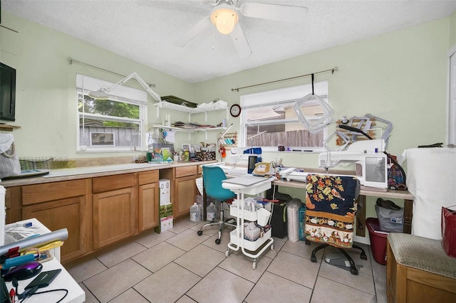 kitchen with a healthy amount of sunlight, light tile patterned floors, a textured ceiling, and ceiling fan