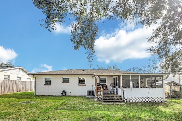 back of property with cooling unit, a yard, a deck, and a sunroom