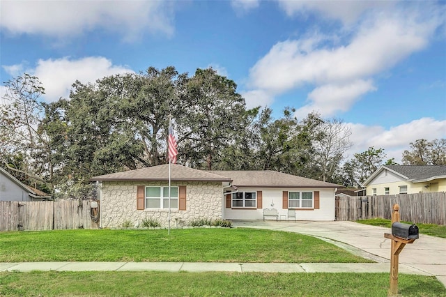 ranch-style home with a front lawn