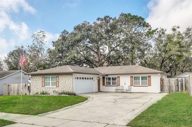 ranch-style home featuring a garage and a front lawn