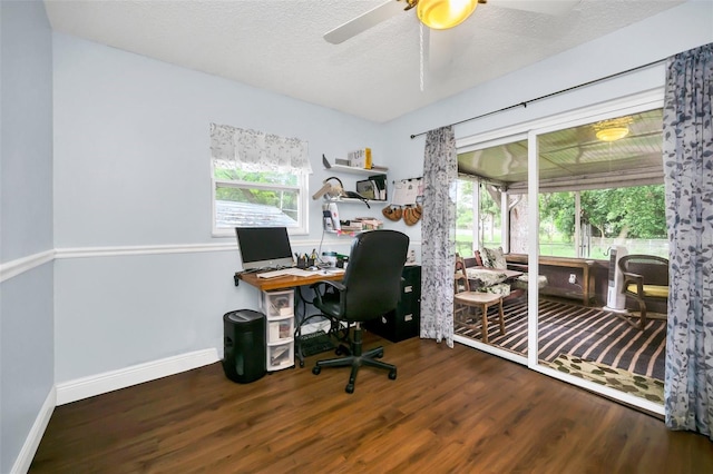 office space featuring ceiling fan, dark hardwood / wood-style floors, and a textured ceiling