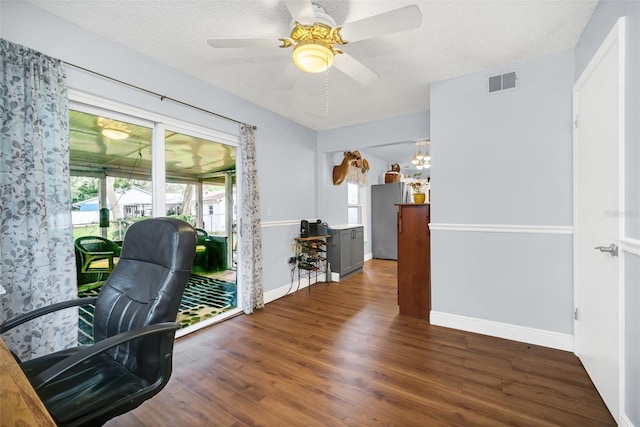 office area with ceiling fan, dark hardwood / wood-style floors, and a textured ceiling