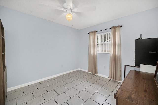 interior space featuring light tile patterned flooring and ceiling fan