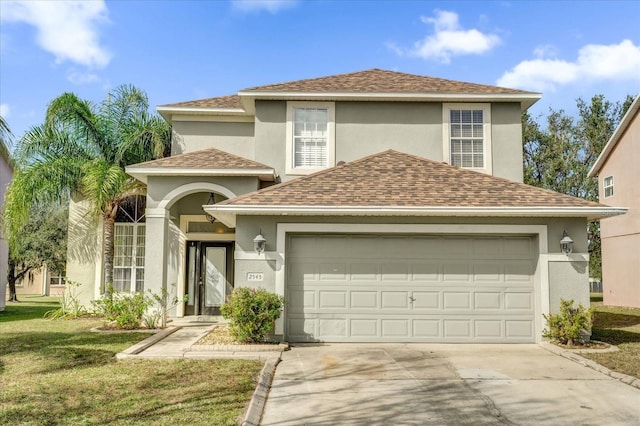 view of front of house featuring a garage and a front lawn