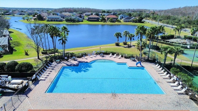 view of pool with a water view and a patio area