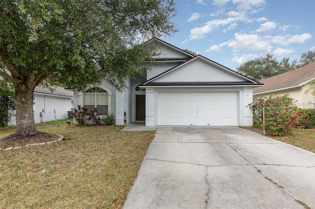 ranch-style house featuring a front yard and a garage