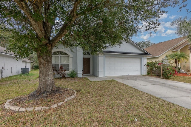 view of front facade featuring a front yard, a garage, and central air condition unit