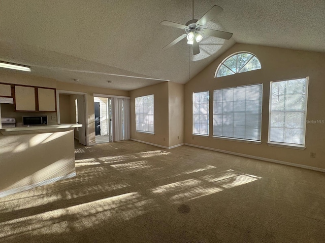 unfurnished living room featuring carpet, a textured ceiling, ceiling fan, and lofted ceiling