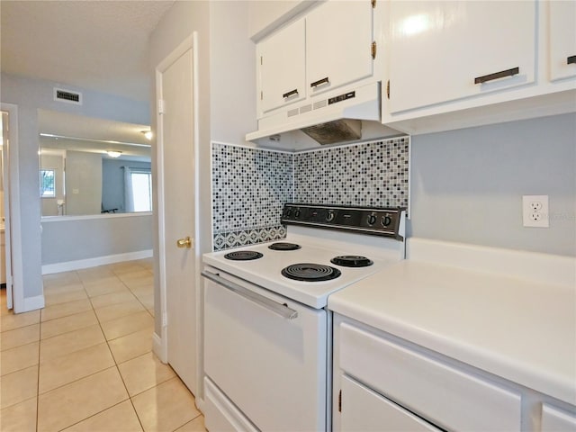 kitchen featuring tasteful backsplash, light tile patterned flooring, white cabinets, and white range with electric cooktop