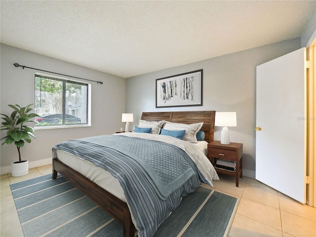 bedroom featuring light tile patterned flooring and a textured ceiling