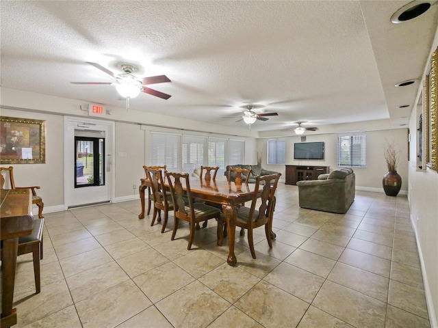 dining room with light tile patterned floors and a textured ceiling