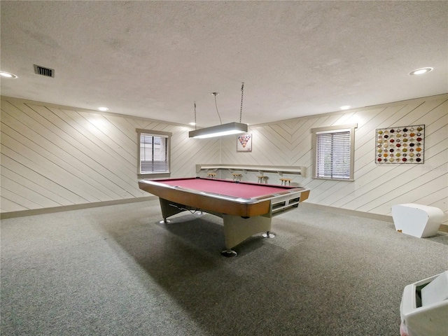 playroom featuring wooden walls, a textured ceiling, and billiards