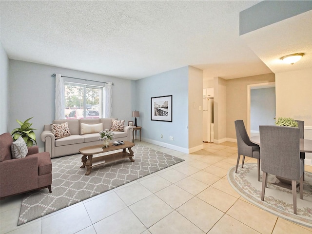 living room featuring light tile patterned flooring and a textured ceiling