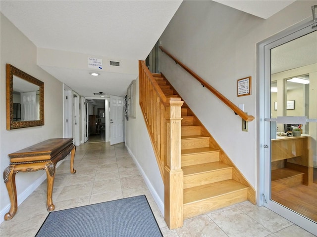 stairs featuring tile patterned floors