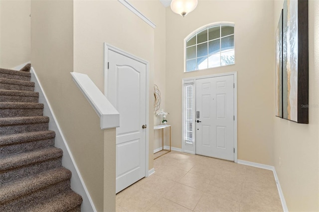 tiled foyer featuring a high ceiling