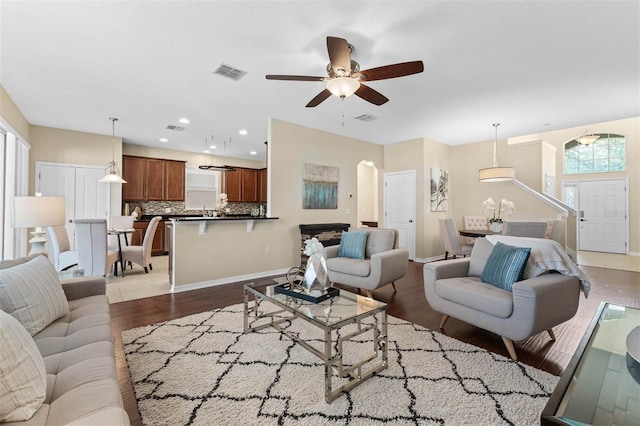 living room with ceiling fan and light hardwood / wood-style floors