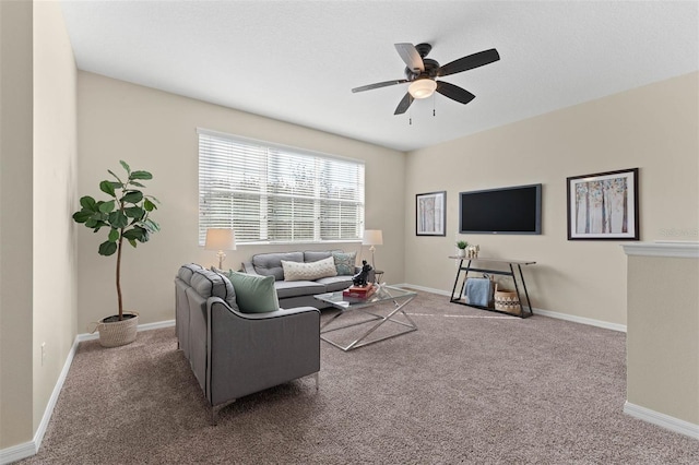 carpeted living room featuring a textured ceiling and ceiling fan