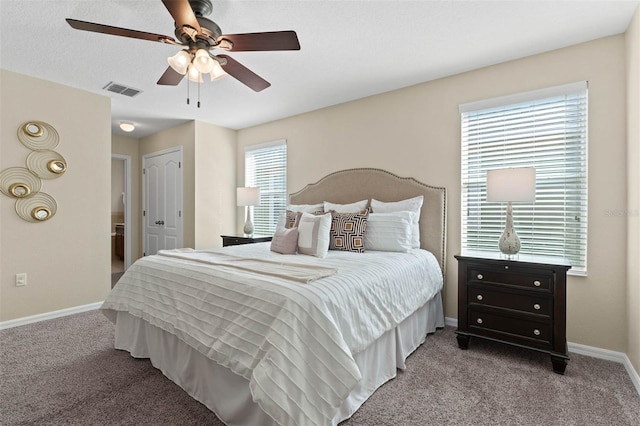 carpeted bedroom featuring multiple windows, ceiling fan, and a closet