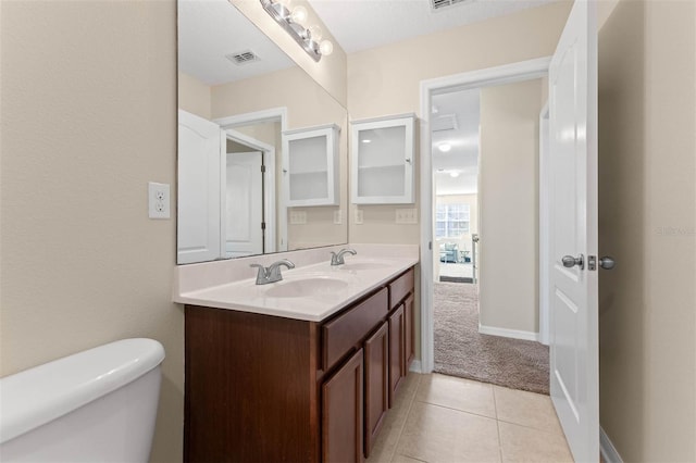 bathroom featuring tile patterned floors, vanity, and toilet