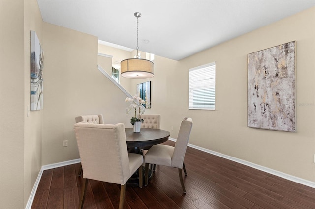 dining space featuring dark wood-type flooring