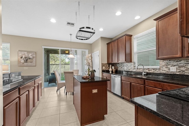 kitchen featuring pendant lighting, a center island, dishwasher, and light tile patterned flooring