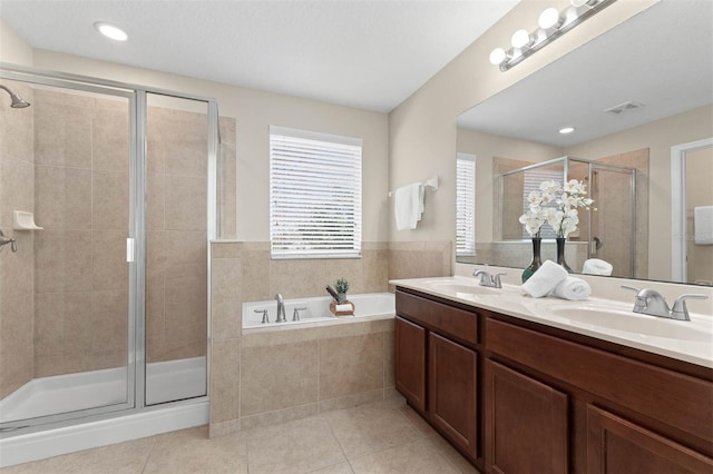 bathroom featuring tile patterned floors, shower with separate bathtub, and vanity