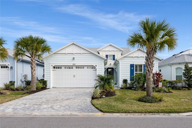 view of front of house featuring a front yard and a garage