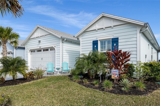 view of front of property featuring a front yard and a garage