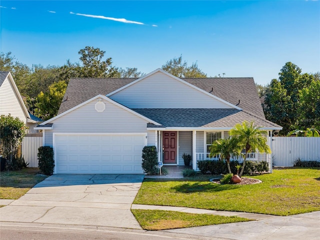 view of front of home with a porch, a garage, and a front yard