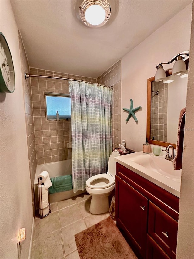 full bathroom featuring toilet, tile patterned flooring, vanity, and shower / tub combo with curtain