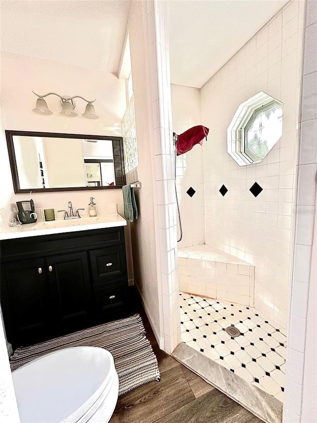 bathroom featuring a shower, hardwood / wood-style floors, and vanity