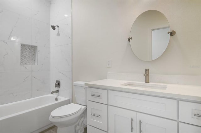 full bathroom featuring toilet, vanity, and tiled shower / bath