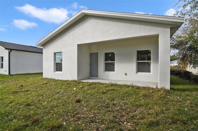 rear view of property with a lawn