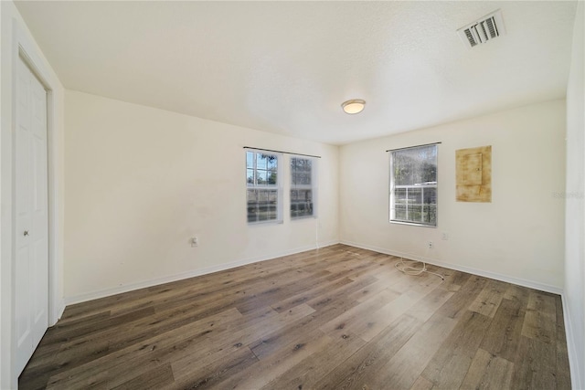 empty room featuring dark hardwood / wood-style flooring