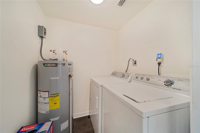 washroom with water heater and washer and dryer