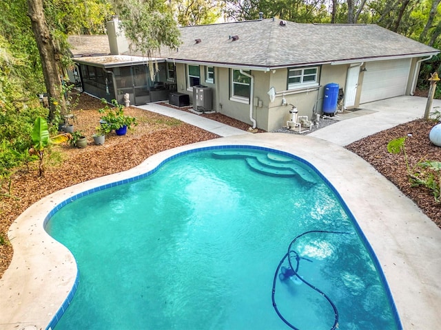 view of swimming pool with a sunroom and central air condition unit