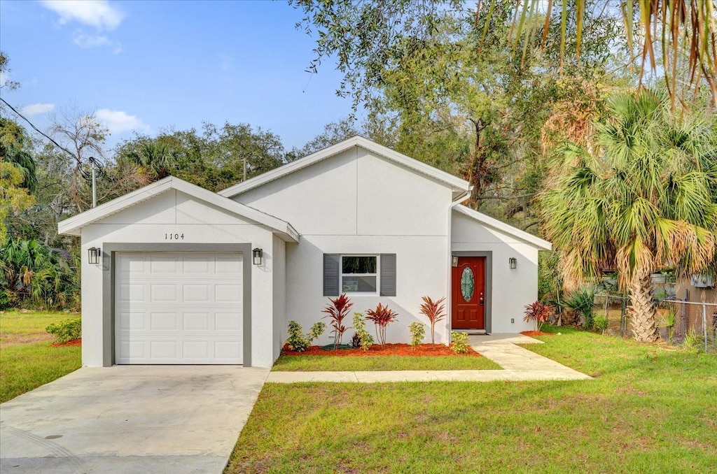 view of front of house featuring a garage and a front lawn