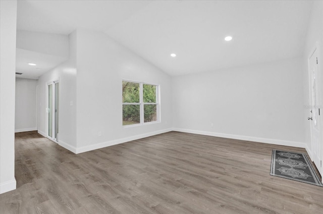 unfurnished living room with vaulted ceiling and light hardwood / wood-style floors