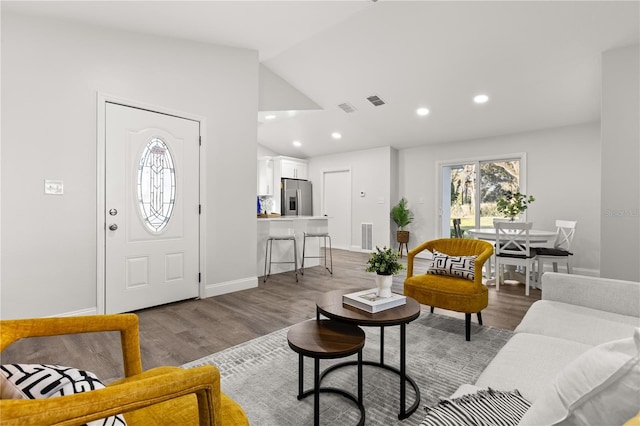 living room with vaulted ceiling and light hardwood / wood-style floors