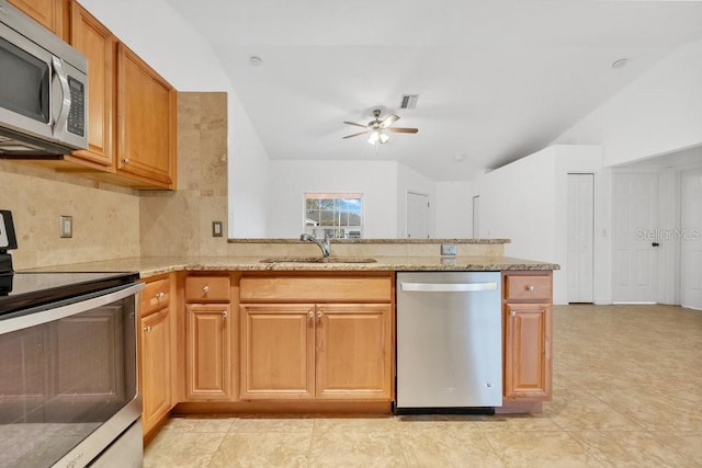 kitchen with ceiling fan, sink, stainless steel appliances, light stone counters, and backsplash