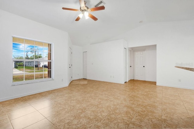 unfurnished room featuring ceiling fan, light tile patterned floors, and lofted ceiling