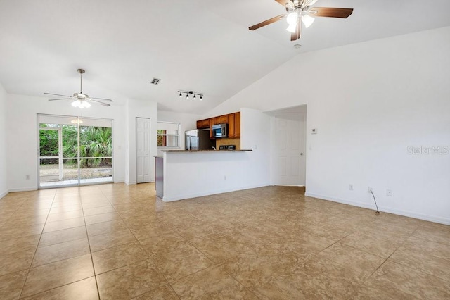 unfurnished living room featuring vaulted ceiling, ceiling fan, and light tile patterned flooring