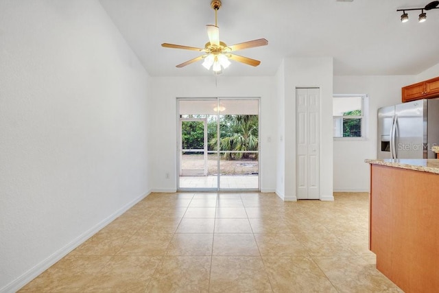 interior space with ceiling fan