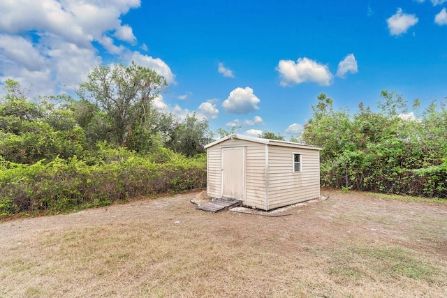 view of outbuilding featuring a lawn