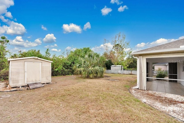 view of yard with a patio and a storage shed