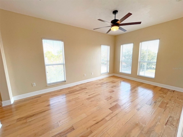 empty room featuring ceiling fan and light hardwood / wood-style floors