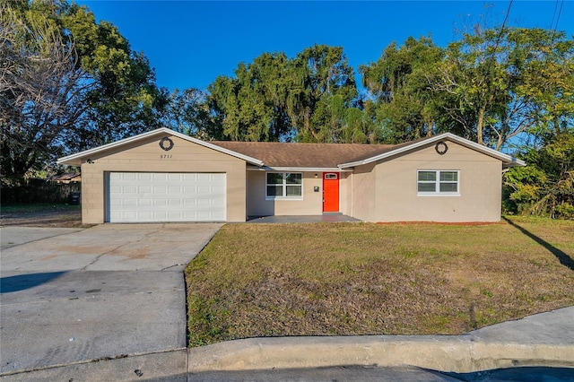 ranch-style house featuring a front lawn and a garage