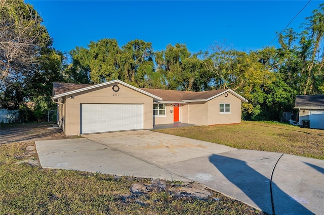 single story home with a front yard and a garage